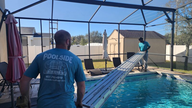 Poolside Screen Repair crew carrying a fresh screen panel along the pool deck during a rescreen