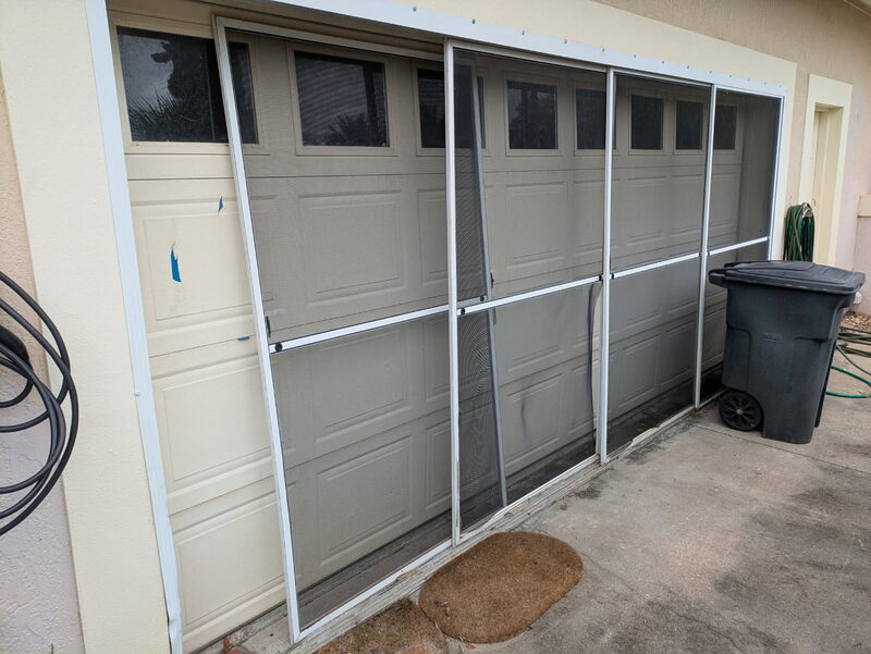 Sliding screen panels fitted across a two-car garage opening